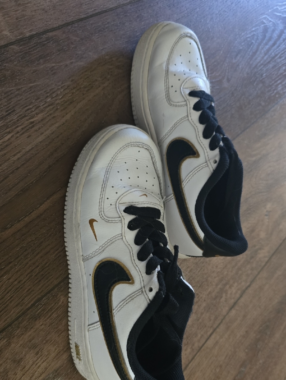 Nike Kids White Sneakers with Black and Gold Swooshes